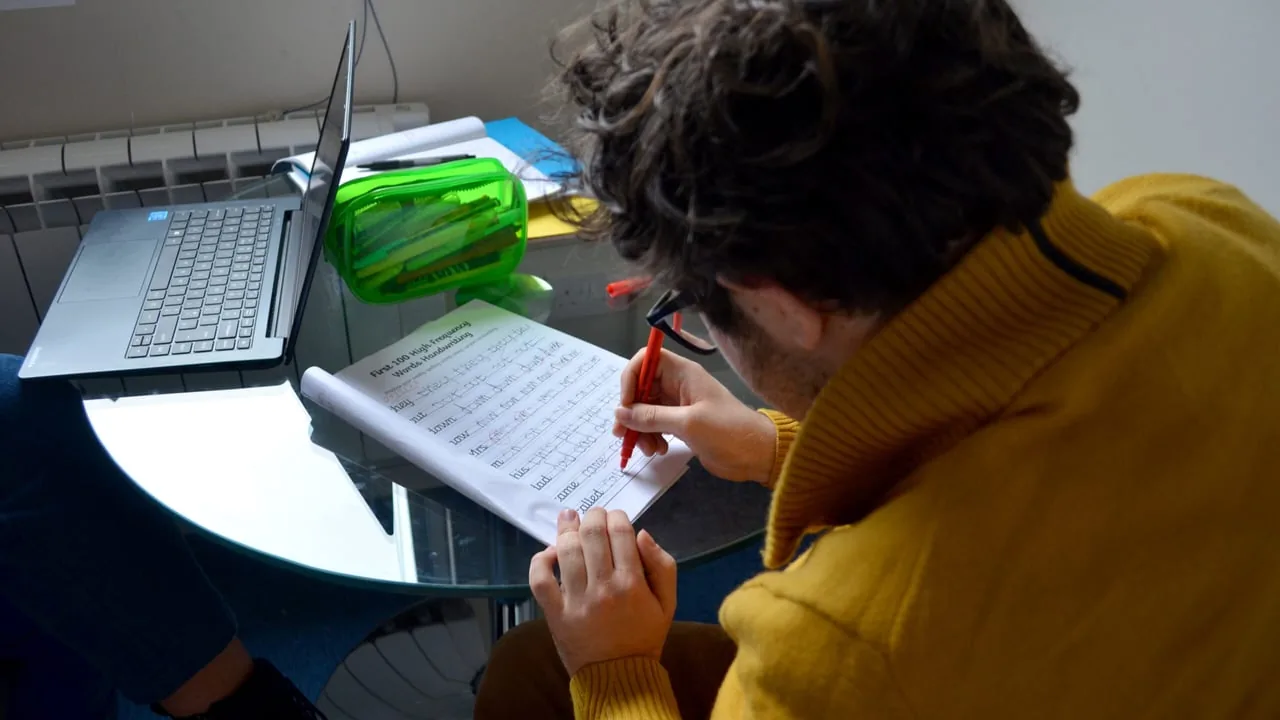 Student working through exam preparation materials